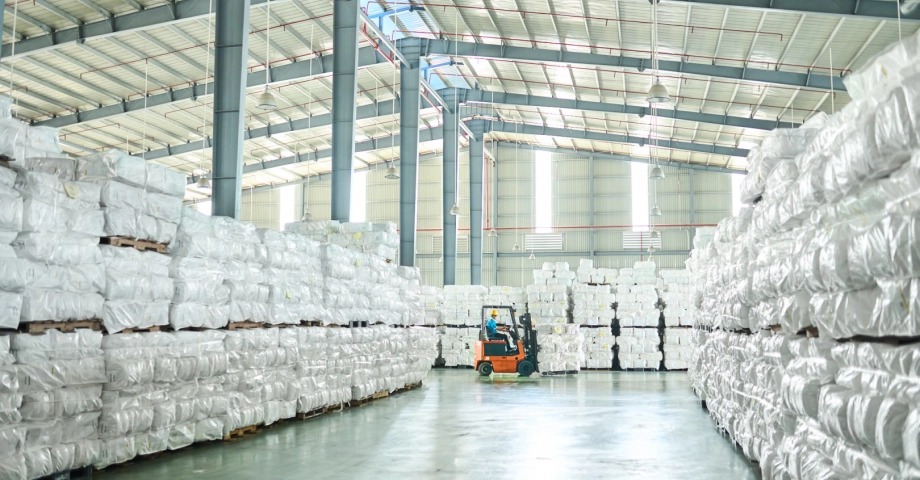 Man drives forklift in manufacturing plant