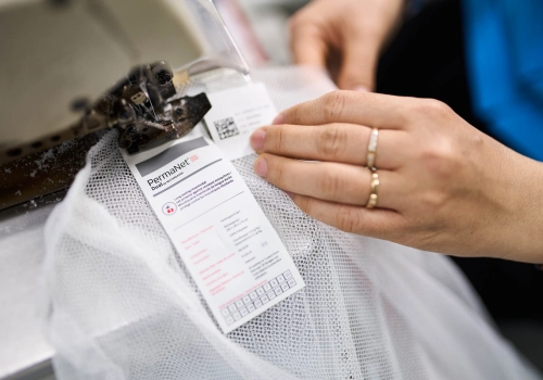 Hands sewing a PermNet Dual mosquito net