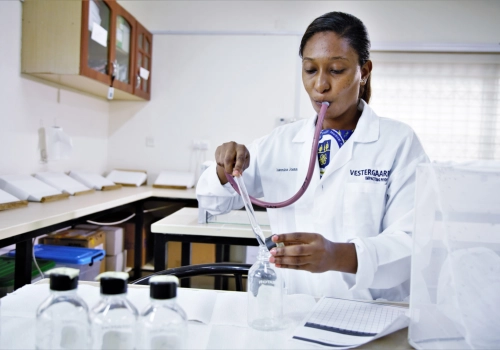 A woman in a lab coat at the Vestergaard-Noguchi Vector Labs in Accra, Ghana