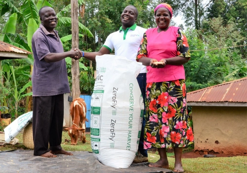 People smiling around a storage bag