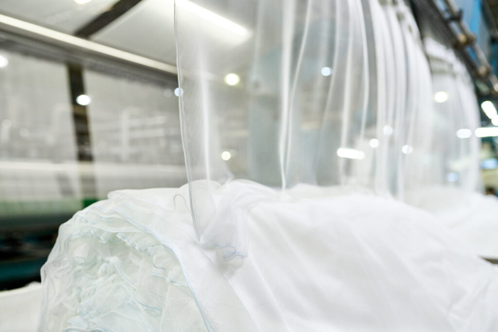 Production of PermaNet® bed nets by Vestergaard for malaria prevention.