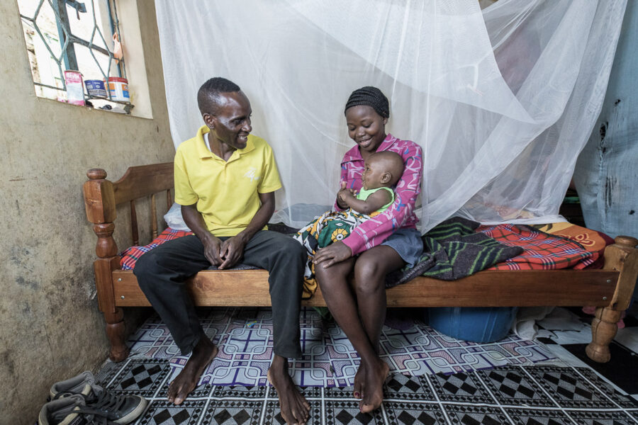 Family under a mosquito net in Uganda